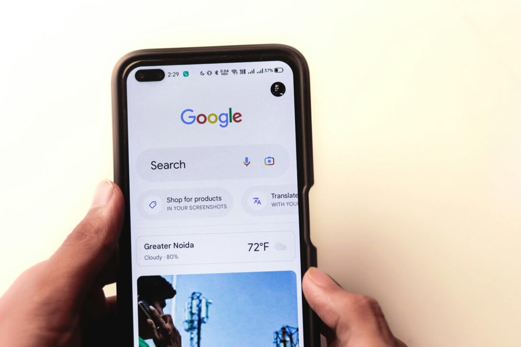 pexels-photo-16629436-16629436 A close-up of a hand holding a smartphone with Google search displayed on the screen.